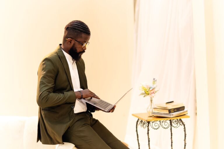 Well-dressed man in Lagos office focused on his laptop, embracing a modern digital workspace.