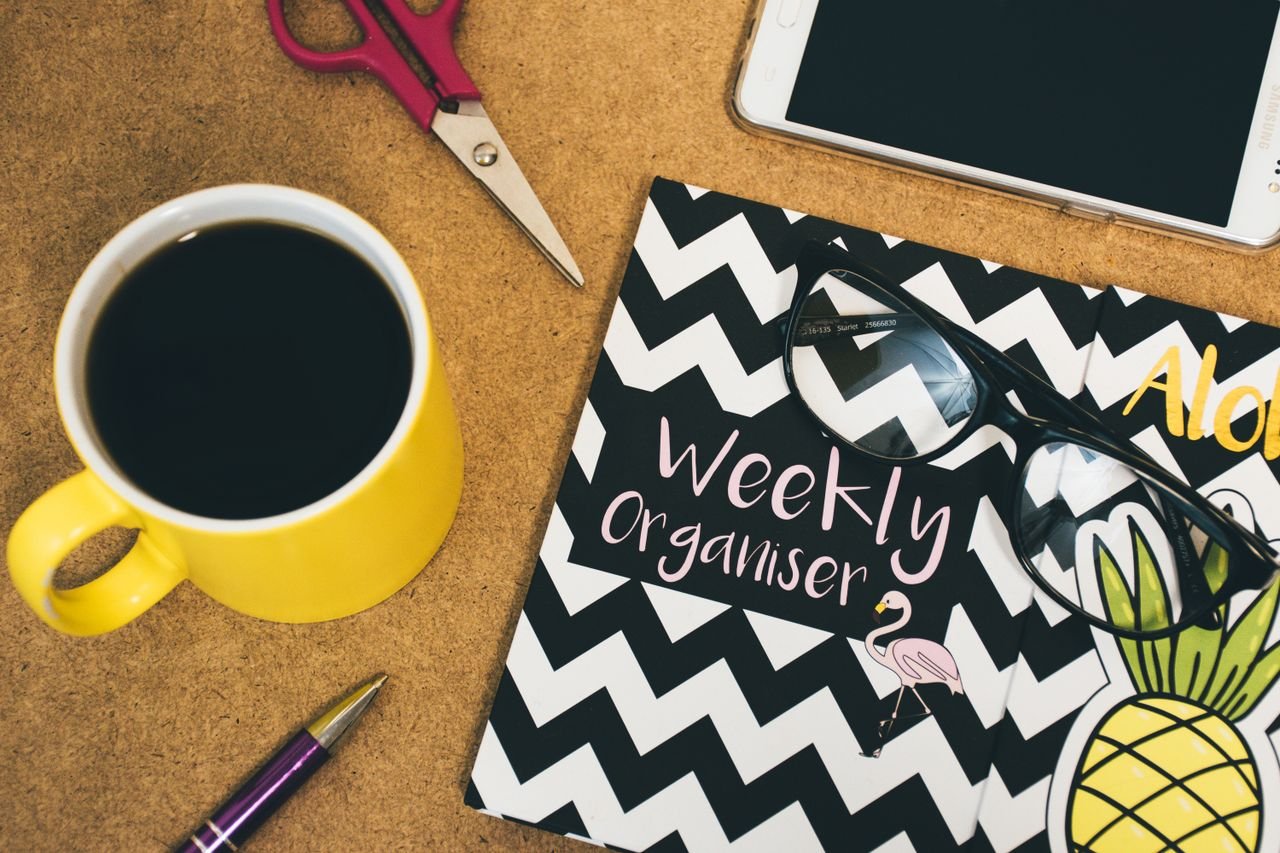 Student creating a weekly study plan using AI tools on a laptop with a digital calendar and task planner